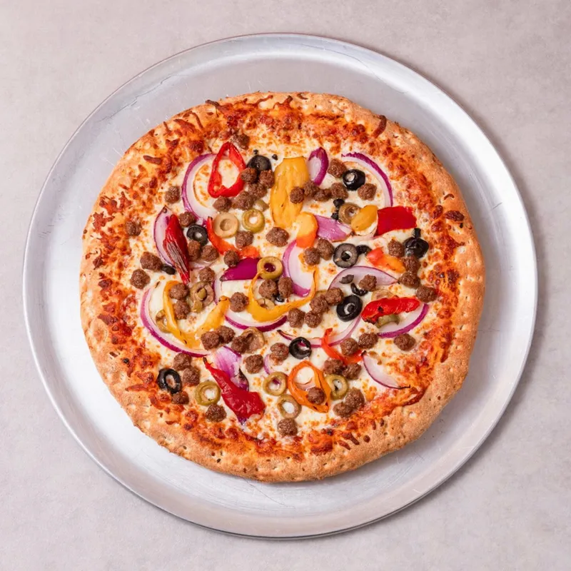 Deluxe pizza with ground beef, olives, peppers and red onion